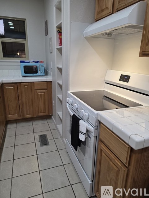 A kitchen with a white oven and sink.