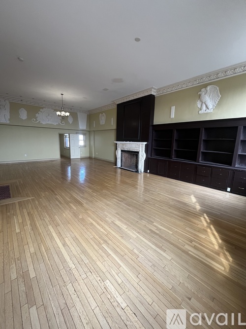 A room with wooden floors and a fireplace.