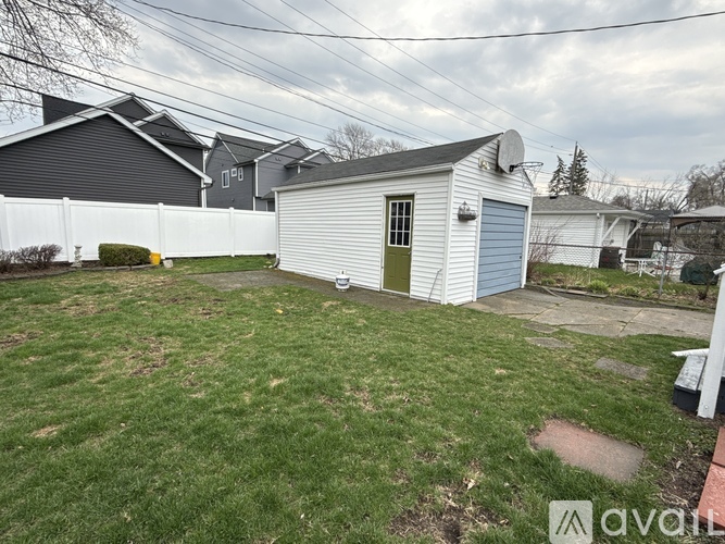 A backyard with a shed and a green door.