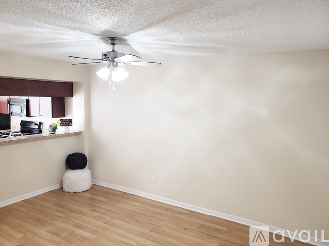 A room with a ceiling fan and a bean bag chair.