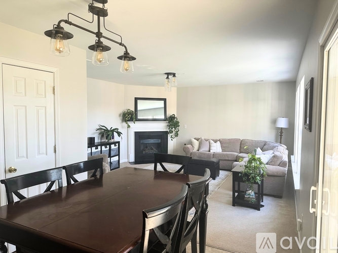 A dining room with a dark wood table and chairs.