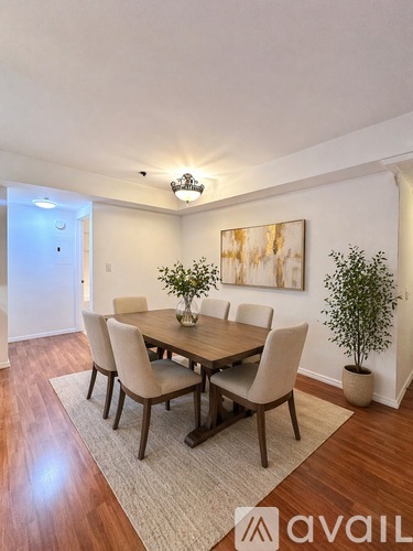 A dining room with a wooden table and chairs.