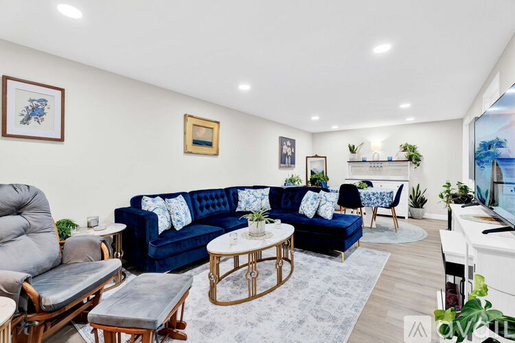A living room with a blue couch and a television.