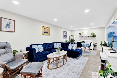 A living room with a blue couch and a television.