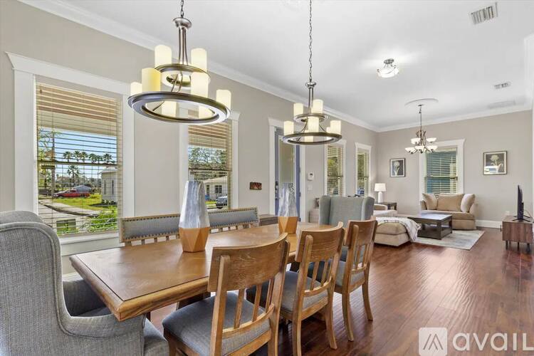 A dining room with a wooden table and chairs.