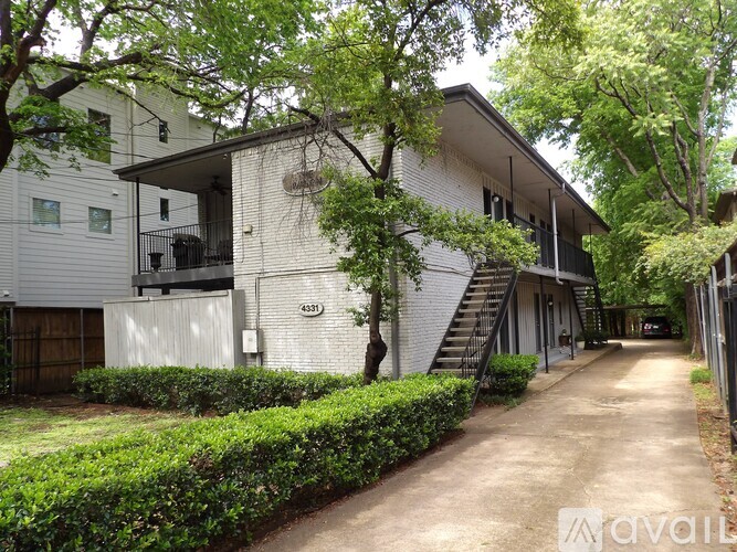 A two-story house with a driveway and a garage.