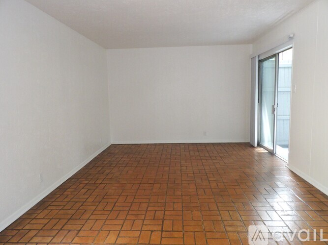 A room with a tiled floor and a sliding glass door.