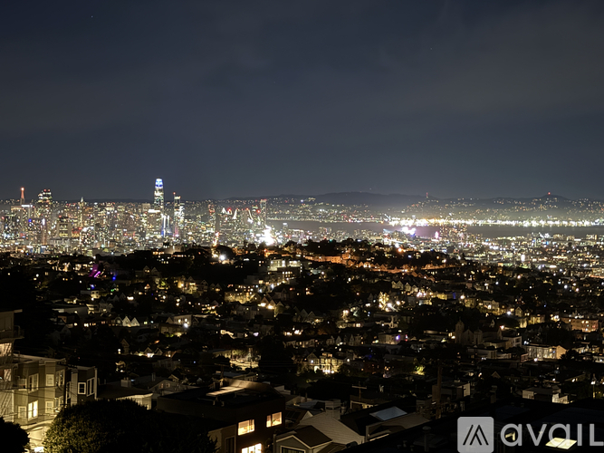 A cityscape at night with numerous buildings illuminated.
