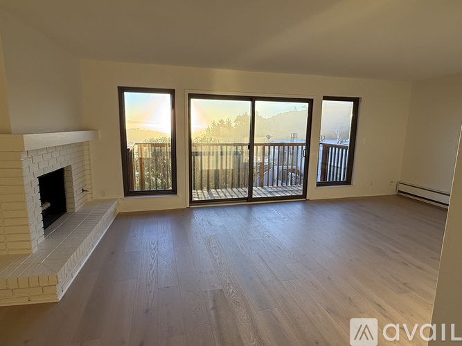 A living room with a fireplace and sliding glass doors.