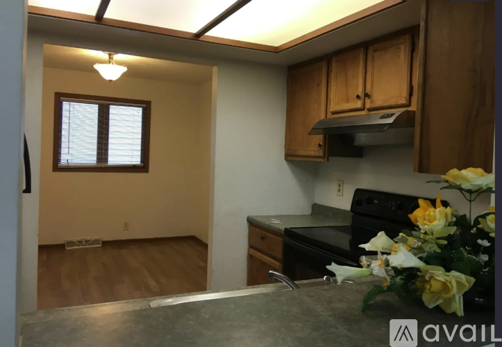 A kitchen with wooden cabinets and a black stove top oven.