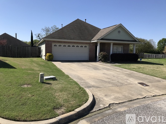 A house with a grey roof and a white garage door.
