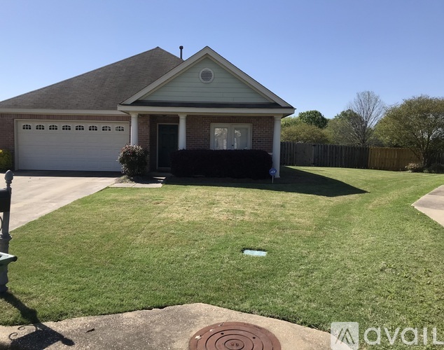 A house with a brown roof and a white garage door.