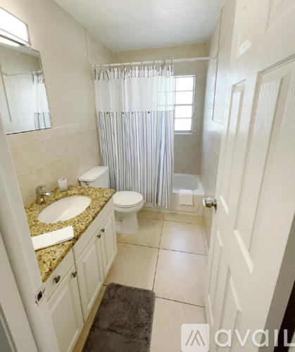 A bathroom with a sink, toilet, and shower.