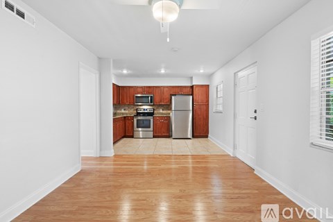 A kitchen with wooden cabinets and a white fridge.