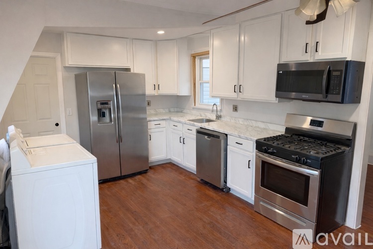 A kitchen with white cabinets and stainless steel appliances.