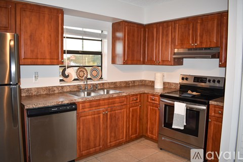 A kitchen with wooden cabinets and stainless steel appliances.