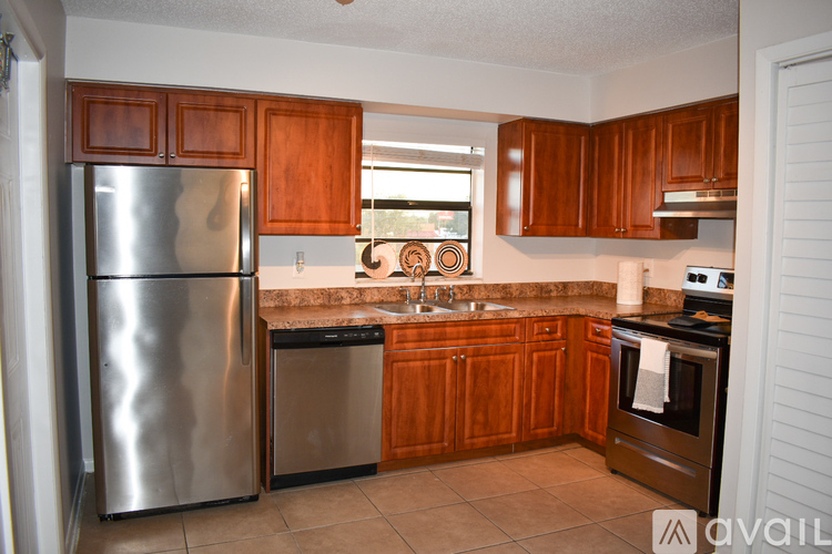 A kitchen with wooden cabinets and stainless steel appliances.