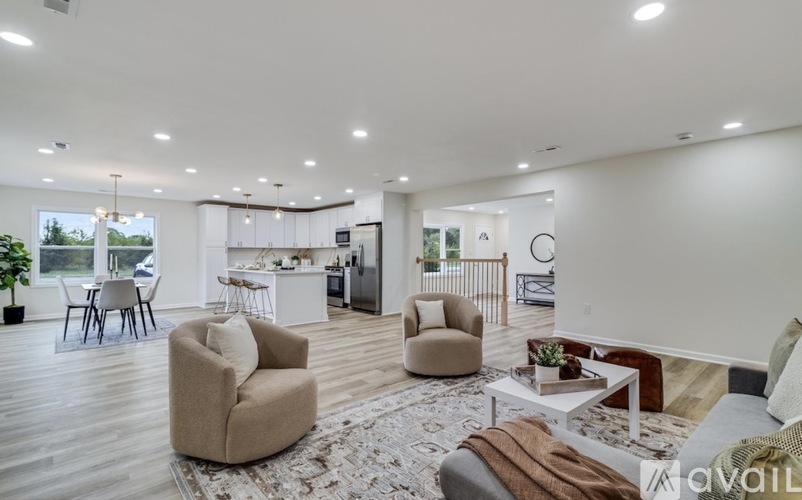 A living room with a white ceiling and a rug on the floor.