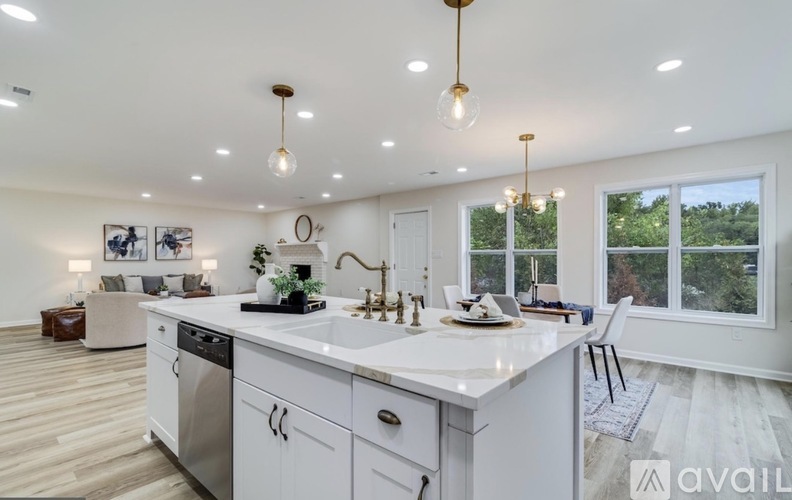 A modern kitchen with white cabinets and a large island.