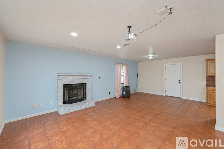 A living room with a fireplace and a tiled floor.