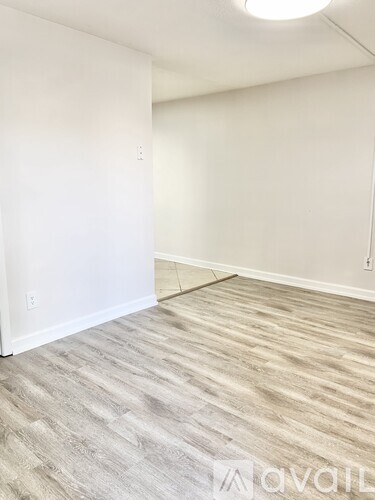 A room with a wooden floor and white walls.