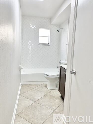 A small bathroom with a toilet, sink, and bathtub.