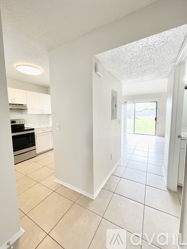 A kitchen with white cabinets and a microwave.