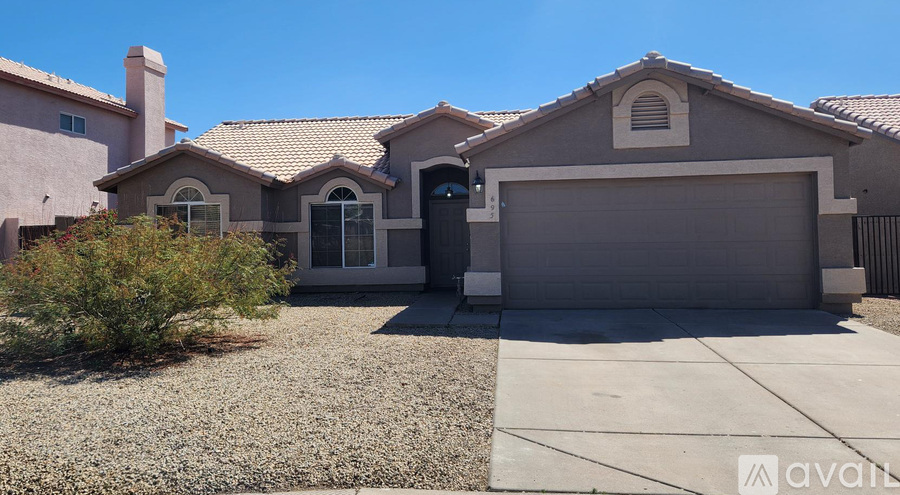 A house with a garage and a driveway in front.