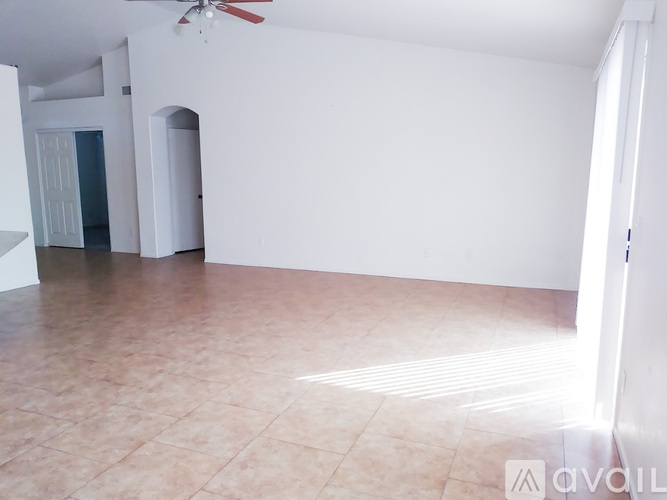 A room with a tiled floor and a ceiling fan.