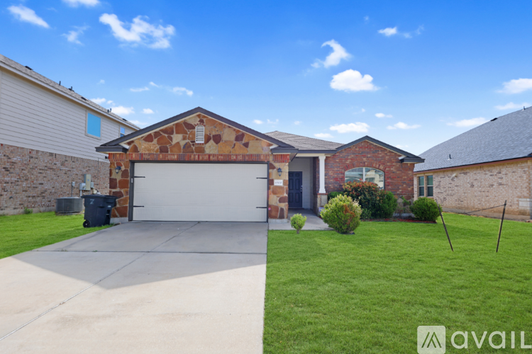 A house with a garage and a driveway in front of it.