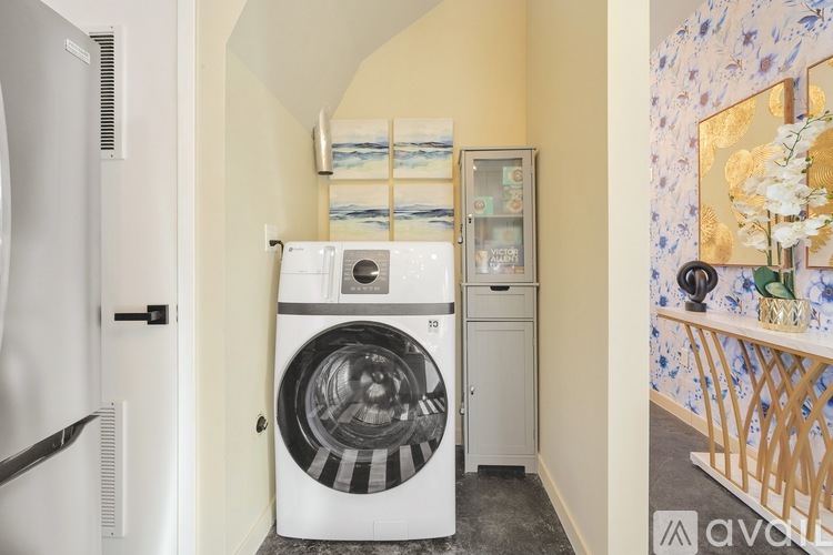 A washing machine is in a small room.