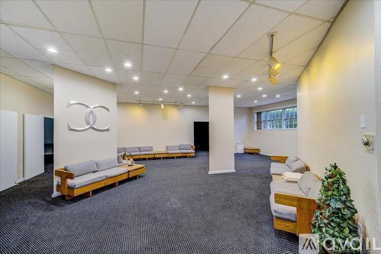 A spacious waiting area with a Coca-Cola logo on the wall.