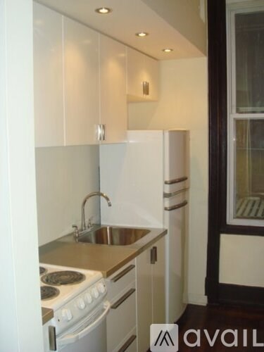 A kitchen with a stove top oven and a sink.