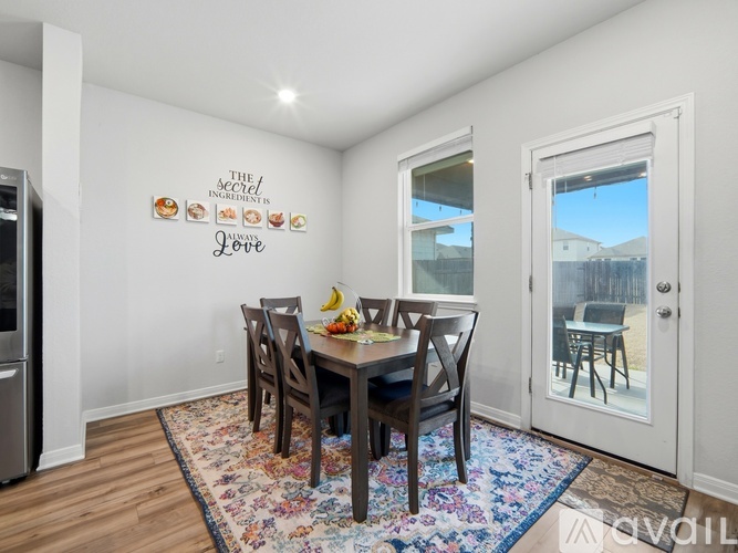 A dining room with a table set for four.