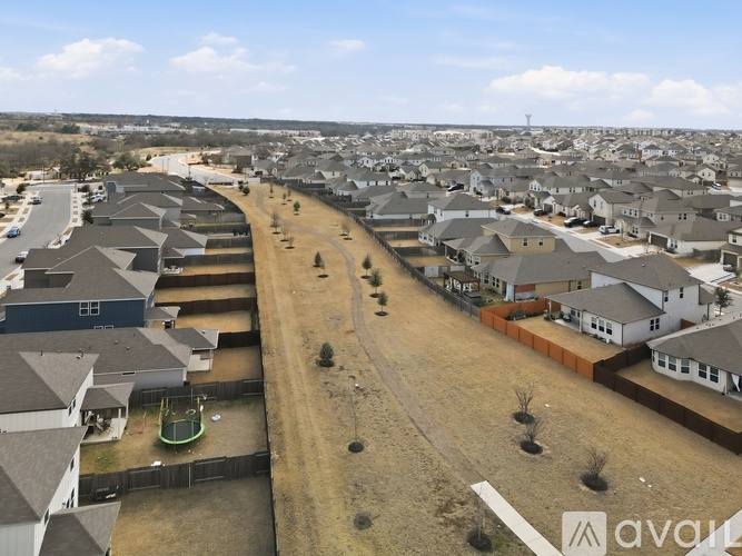 A bird's eye view of a residential area with houses and a playground.