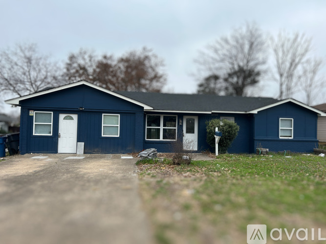 A blue house with a white door and windows is for sale.