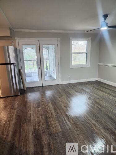 A room with a wooden floor and a ceiling fan.