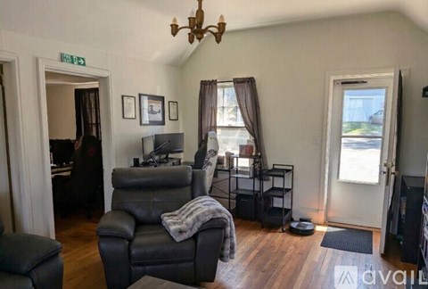A living room with a grey sofa and a black chair.