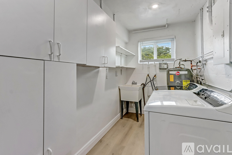 A small laundry room with a washer and dryer.