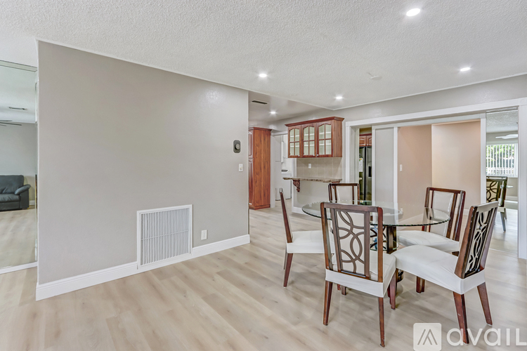 A living room with a dining table and chairs.