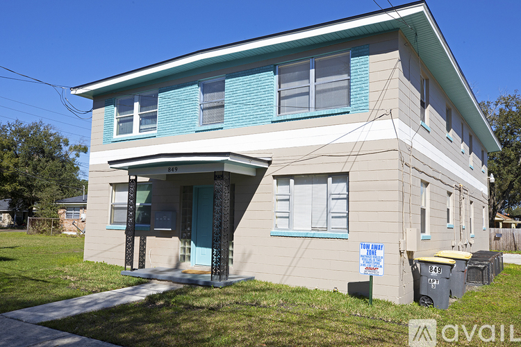 A two-story house with a blue door and windows.