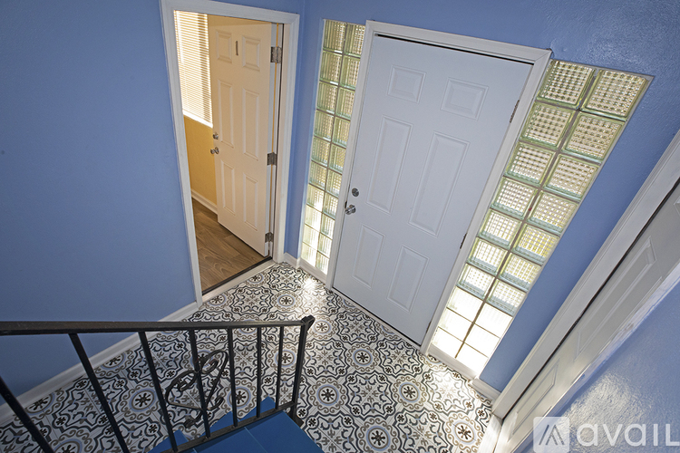 A hallway with a staircase and two doors.