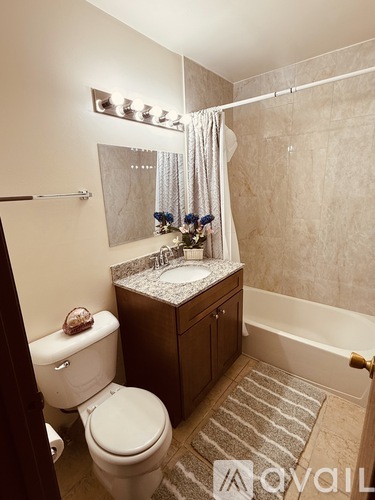 A bathroom with a toilet, sink, and bathtub.
