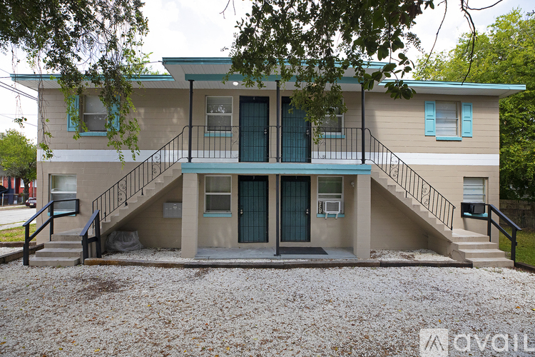 A two-story house with a balcony on the second floor.