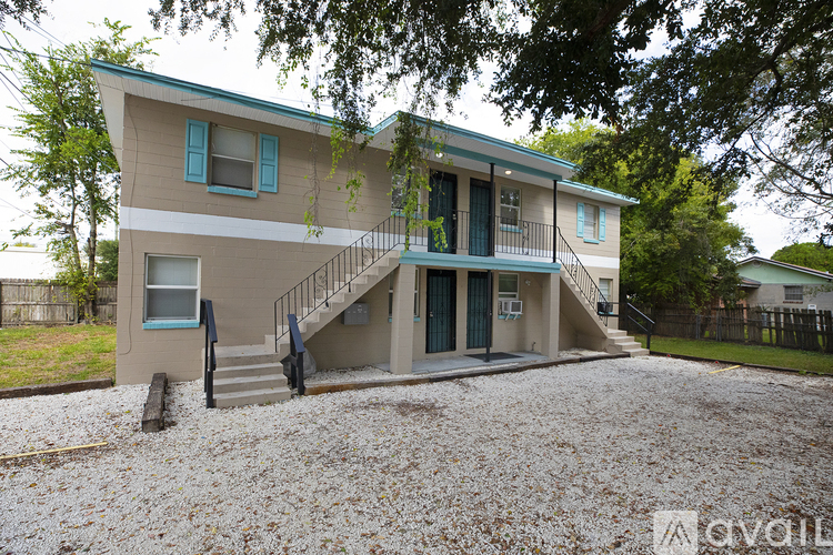 A two-story house with a balcony on the second floor.