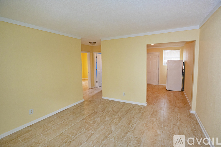 A room with yellow walls and a wooden floor.