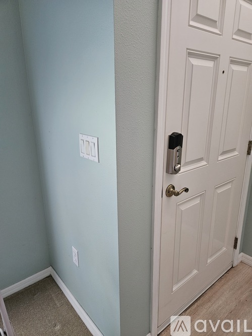 A white door with a silver handle is on the right side of the image.