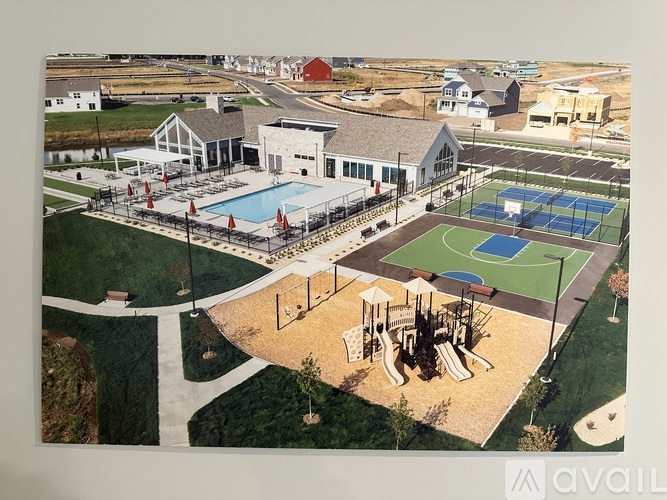 A large building with a pool and a tennis court.