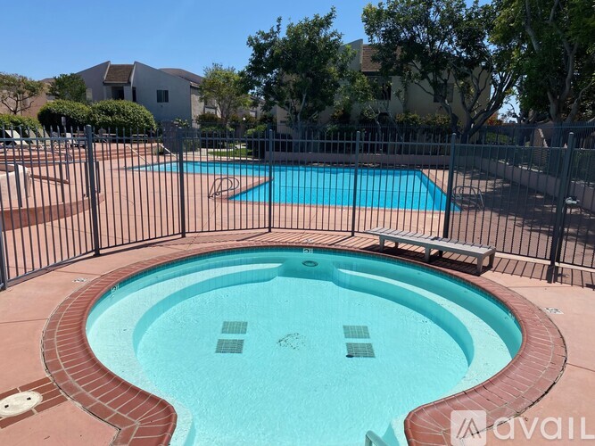 A pool with a hot tub in the middle of it.