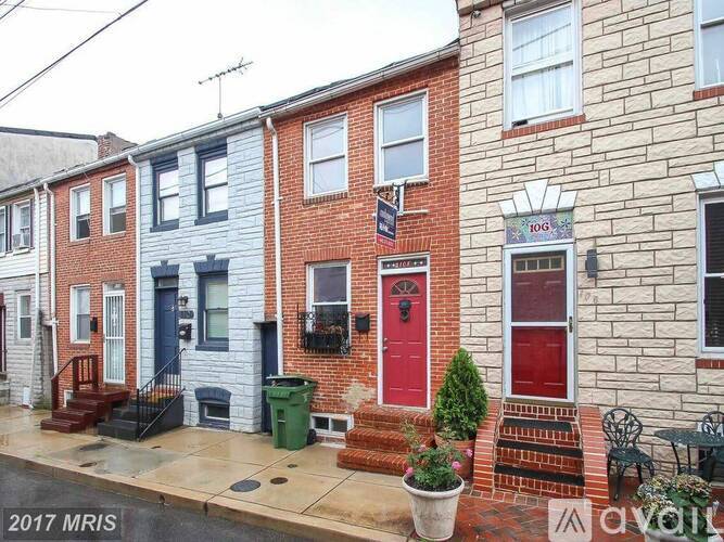 A row of houses with different colored front doors.